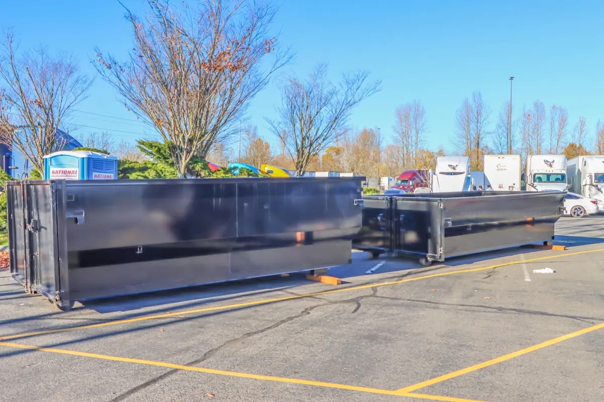 Professional dumpster rental service with roll-off container on residential driveway in Garden City